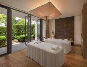 two beds in a room with sliding glass doors at Grand Hyatt Erawan Bangkok in Bangkok +122 photos