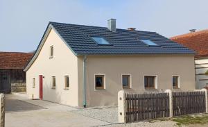 a white house with a black roof at Ferienhaus Wittmann in Beilngries