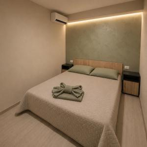 a bedroom with a bed with a robe on it at Amalya in Constanţa