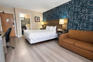 a hotel room with a bed and a couch at Comfort Inn in Huntsville +32 photos