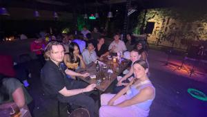 a group of people sitting at a party at HUBS Hostel Yogyakarta in Yogyakarta