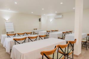 a room with white tables and chairs in it at Comfort Inn Tampico in Tampico +47 photos