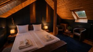 a bedroom with a large bed in a attic at Pension Nippgen in Radebeul