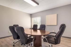 a conference room with a wooden table and chairs at Quality Inn & Suites CVG Airport in Erlanger +107 photos