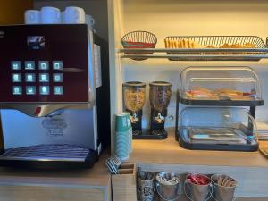 a refrigerator with a coffee maker and some food at Unisotel Bollène A7 Ex-Hotel F1 in Bollène +22 photos