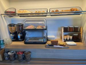 a shelf in a kitchen with food and bread at Unisotel Bollène A7 Ex-Hotel F1 in Bollène