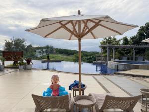 a little girl sitting in at Alta Vista Residences H102 in Boracay