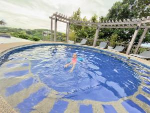 a young child swimming in a large pool at Alta Vista Residences H102 in Boracay +13 photos