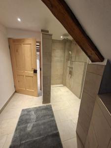 a large bathroom with a shower and a wooden door at Ferienhaus Wittmann in Beilngries