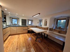 a kitchen with a table and a bench in it at Ferienhaus Wittmann in Beilngries +12 photos