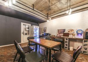 a kitchen with a table and chairs in a room at Chuncheon Urbane Hotel in Chuncheon