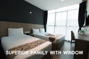 a hotel room with two beds and a window at Hotel 99 Kuala Lumpur City in Kuala Lumpur +63 photos