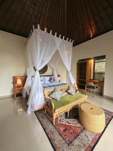 a bedroom with a bed with a canopy at Lira House by Yukaya Escape in Tegalalang +45 photos