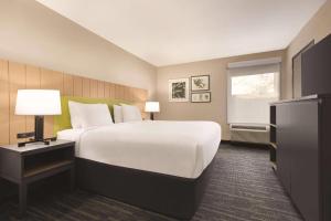 a hotel room with a large bed and a window at Country Inn & Suites by Radisson, Dunn I-95 in Dunn +23 photos