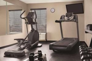 a room with a gym with a treadmill and a elliptical at Country Inn & Suites by Radisson, Dunn I-95 in Dunn