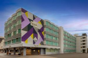 a building with a geometric design on it at Spark By Hilton Seattle Airport in Seattle
