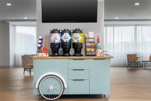a drink cart with bottles on top of it at Spark By Hilton Seattle Airport in Seattle