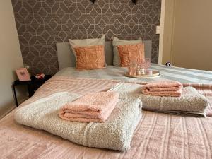 a bedroom with a bed with two towels on it at Le nid des étoiles - Tram & Centre in Dijon