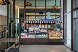 a bakery with a person standing behind a counter at Kantary Hotel Korat in Nakhon Ratchasima +45 photos