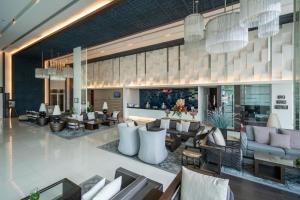 a lobby of a hotel with couches and chairs at Kantary Hotel Korat in Nakhon Ratchasima