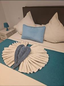 a bed with a hat on top of it at Sarl Valinco Locations in Olmeto
