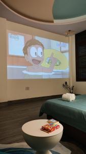 a room with a screen with a monkey on the wall at Behomestay in Hai Phong
