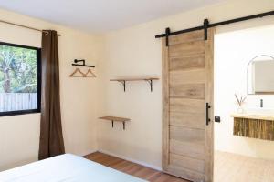 a bedroom with a sliding door and a sink at Red Palm Villa in San Vicente +30 photos