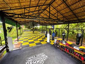 an overhead view of a stage with a yellow and black floor at Yod Khao Muay Thai Camp in Ban Nok