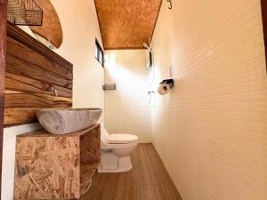 a bathroom with a toilet and a sink at Yod Khao Muay Thai Camp in Ban Nok