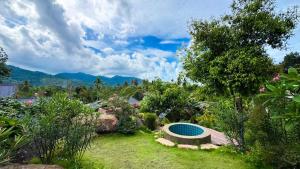 a garden with a swimming pool in the grass at Yod Khao Muay Thai Camp in Ban Nok +5 photos