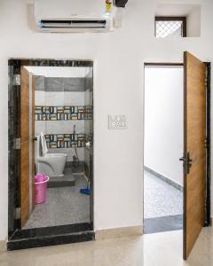a bathroom with a toilet and a mirror at Lighthouse Hostel in Udaipur