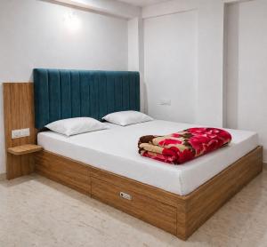 a bedroom with a bed with a blue headboard at Lighthouse Hostel in Udaipur +10 photos