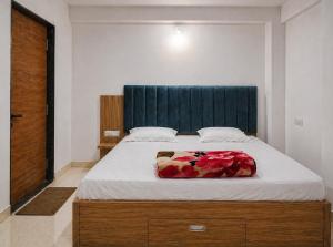 a bed with a blue headboard in a bedroom at Lighthouse Hostel in Udaipur