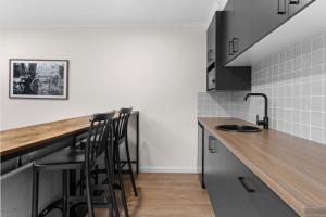 a kitchen with a counter and stools in it at Barooga Hotel in Barooga
