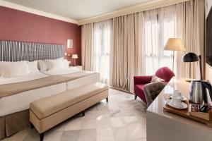 a hotel room with a bed and a chair at Vincci Albayzin in Granada +55 photos