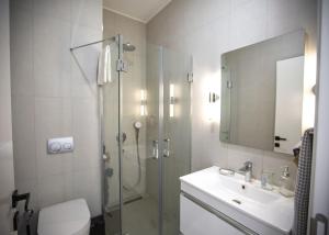a bathroom with a shower and a toilet and a sink at Aqualina E4-1 by HolidayKeys in Kyrenia +14 photos