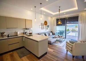 an open kitchen and living room with a couch at Aqualina E4-1 by HolidayKeys in Kyrenia