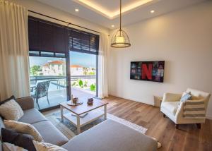 a living room with a couch and a table at Aqualina E4-1 by HolidayKeys in Kyrenia