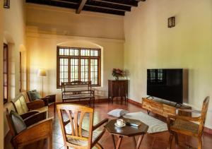 a living room filled with furniture and a flat screen tv at Villa Mariam in Cheruvalli