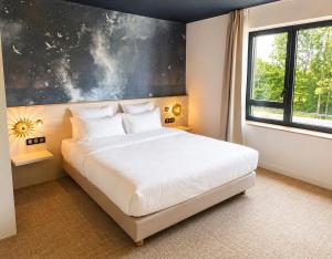 a bedroom with a large white bed and a window at The Originals Boutique, Osmo Hôtel, Rennes Sud Chantepie in Chantepie +111 photos