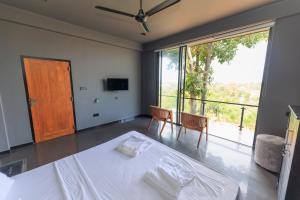 a bedroom with a bed and a large window at Secret Paradise Edge in Weligama +90 photos
