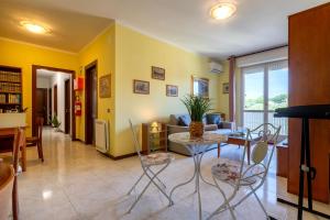 a living room with a table and chairs at Cuncordu Affittacamere- Sassari in Sassari