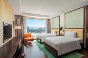 a hotel room with two beds and a television at Hilton Da Nang in Danang +37 photos