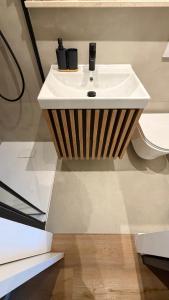 a bathroom sink with two black cups on it at Design Apartment Arndt in Neustadt an der Weinstrasse in Neustadt an der Weinstraße +35 photos