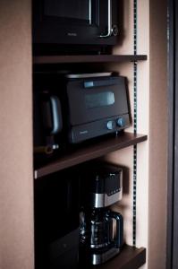 a coffee maker and a microwave on a shelf at monel in Nakafurano +34 photos