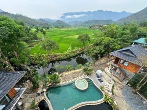 an aerial view of a villa with a swimming pool and mountains at Mai Châu Home in Mai Châu
