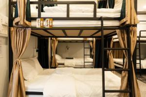 a group of bunk beds in a room at Nam Phou Hostel in Thakhek