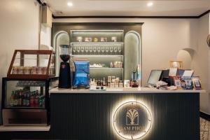 a bar in a restaurant with a counter and a refrigerator at Nam Phou Hostel in Thakhek