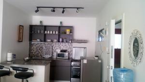 a kitchen with a counter and a refrigerator at Modern apartment for work and rest in Kiambu
