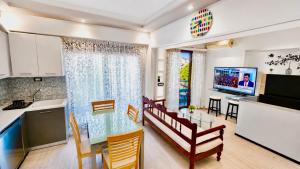 a kitchen and living room with a glass table in a kitchen at Atlantis Hotel in Agios Nikolaos